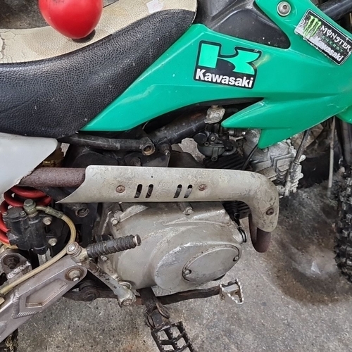 650 - Star Lot: Kawasaki dirt bike with green body and Monster Energy branding. Engine close-up detailing ... 