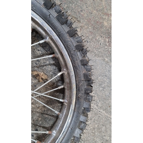 651 - Pair of motocross wheels, featuring 60/100-14 knobby tires with spoke rims.