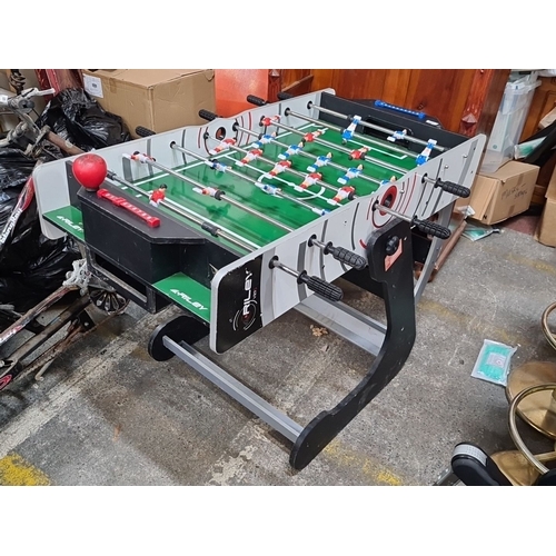 665 - Riley VR-90 folding foosball table, featuring a green playing surface with red and blue teams. Sturd... 