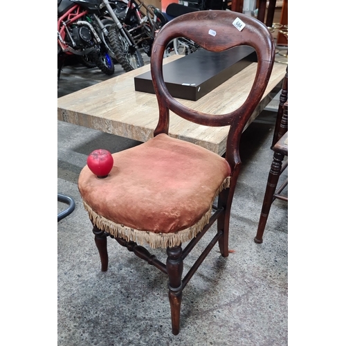 684 - An early Victorian mahogany balloon back occasional chair with fringed velvet upholstered seat.