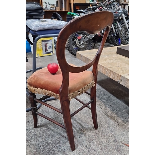 684 - An early Victorian mahogany balloon back occasional chair with fringed velvet upholstered seat.