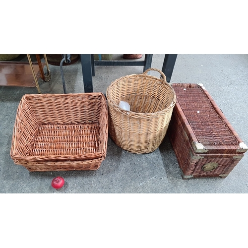 693 - Three woven wicker baskets, including one rectangular, one round with handle, and one box-style with... 