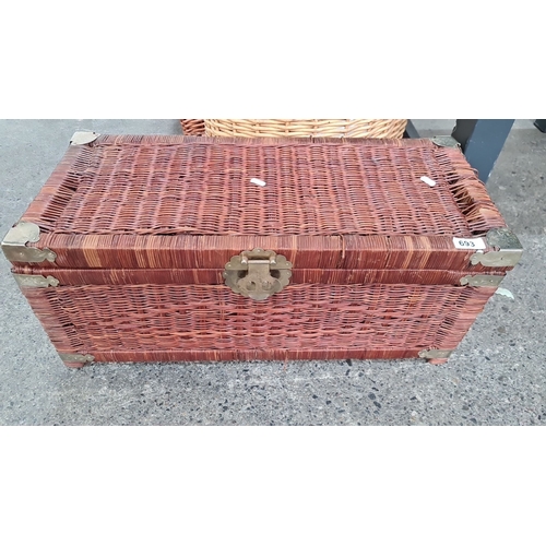 693 - Three woven wicker baskets, including one rectangular, one round with handle, and one box-style with... 