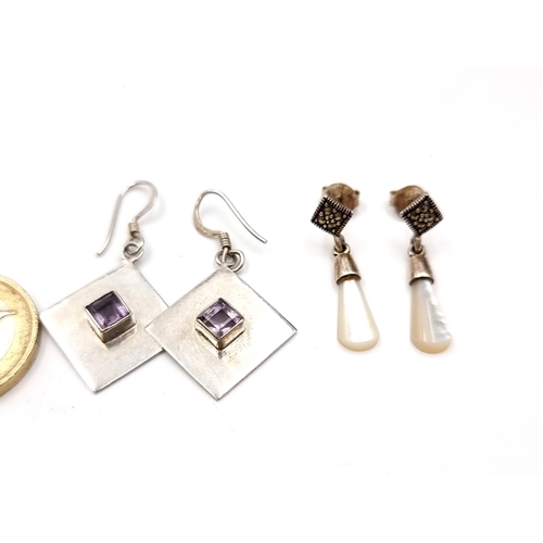 505 - A pair of sterling silver earrings suitable for pierced ears with amethyst set mounts. Total weight ... 