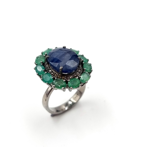 575 - A most attractive natural large sapphire stone ring with emerald stone surround mounted in sterling ... 