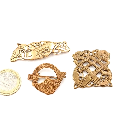 592 - A very nice collection of three gold metal celtic design brooches. All with pins intact. Total weigh... 