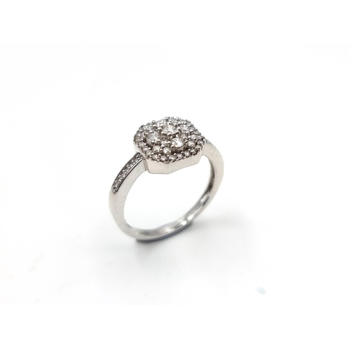 544 - Star lot : A nine carat white gold brilliant cut diamond cluster ring. Est. weight of diamond - 0.5 ... 