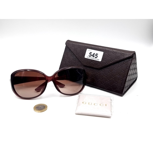 545 - A super pair of Gucci sunglasses marked 'Made in Italy' set with gold accents to frames. Together wi... 