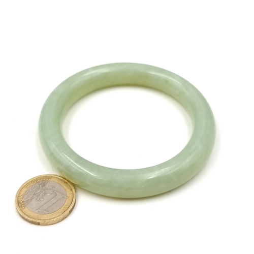 547 - A jade vintage bangle. Weight - 48 grams. Stone cold to touch. Lovely colour on this one