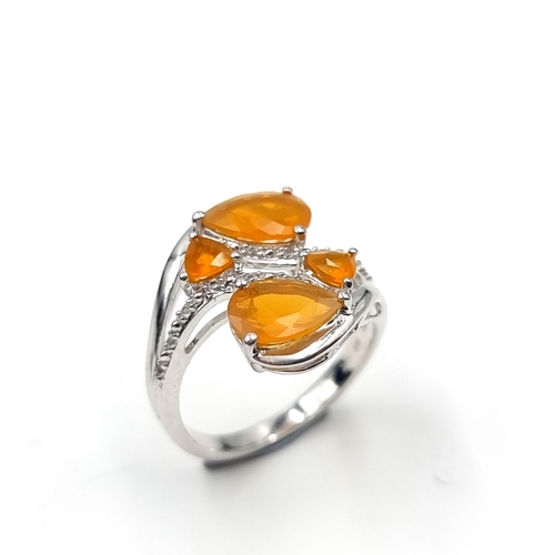 549 - A most attractive multi-stone tangerine topaz gem set ring. Size - O. Weight - 3.95 grams. Boxed.