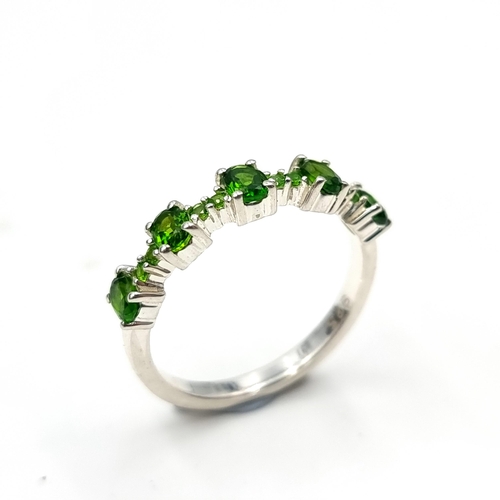 554 - A five stone green topaz ring set in sterling silver. Size - Q. Weight - 2.7 grams. Boxed.