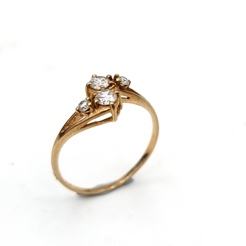 555 - A nine carat gold four stone twist set moissanite stone ring. Size - M. Weight - 1.4 grams. Boxed.