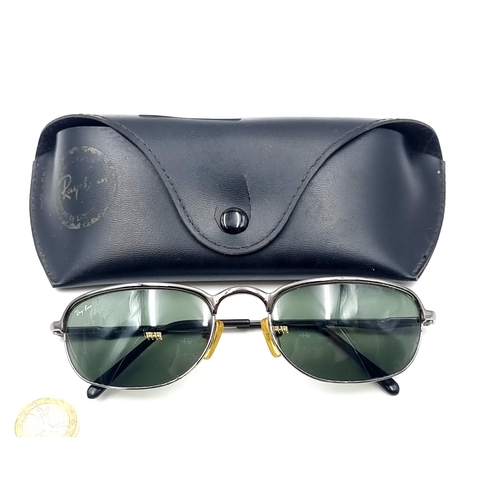 559 - A pair of original Ray-Ban as new sunglasses marked 'Made in Italy'. Comes with leather pouch.