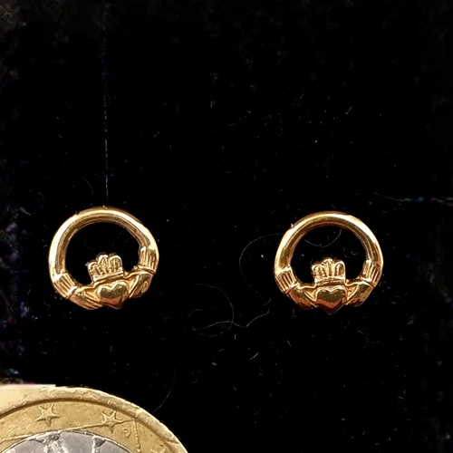 560 - A pair of nine carat gold claddagh stud earrings. Weight - 0.9 grams. Boxed.