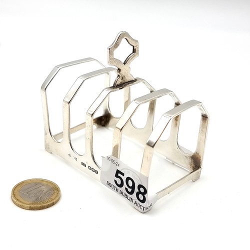 598 - A four section sterling silver toast rack hallmarked Sheffield - 1957. Dimensions - 8 x 5 cms. Weigh... 