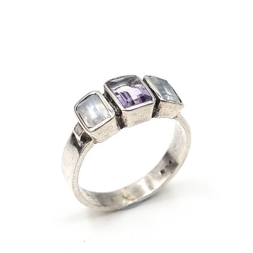 611 - A sterling silver three stone gem set ring set with amethyst and moonstones. Ring size - S. Weight -... 