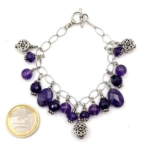 615 - A pretty amethyst stone bracelet set with sterling silver and T-bar clasps. Weight - 23.54 grams. Bo... 