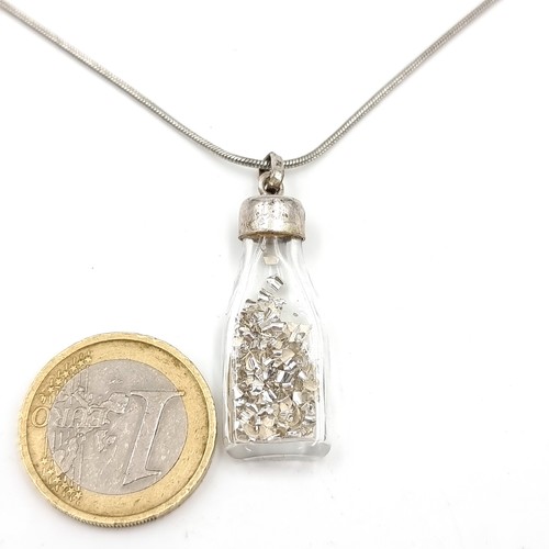 623 - An unusual sterling silver bottle pendant with Silver shaving and sterling silver chain. Length - 42... 