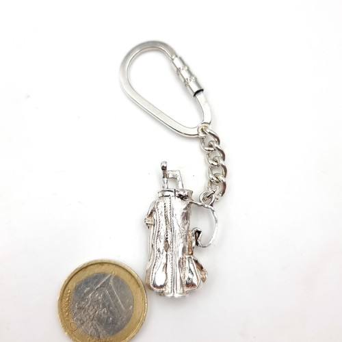 626 - A sterling silver hallmarked Birmingham key ring in a form of bag if golf clubs. Total weight - 24.3... 