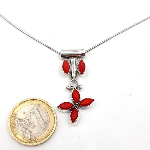 628 - A coral pendant necklace set in sterling silver and chain. Length - 46 cms. Pendant - 4 x 1 cms. Wei... 