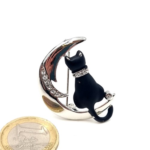 632 - A silver gem set black cat and moon brooch. Pin intact. Weight - 7.6 grams.