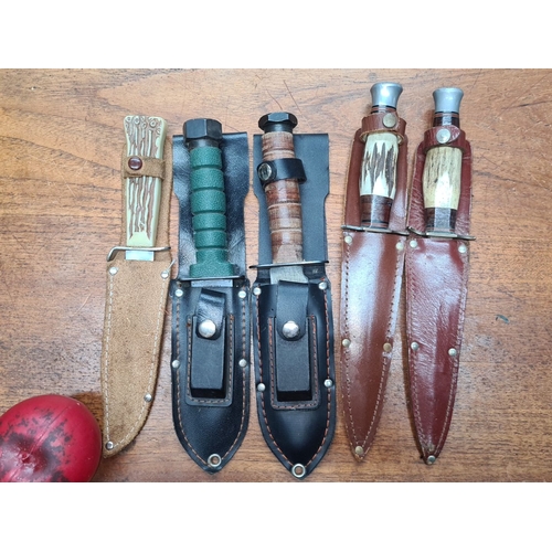 700 - A collection of six vintage fixed-blade hunting knives with sheaths. Various handle materials and de... 