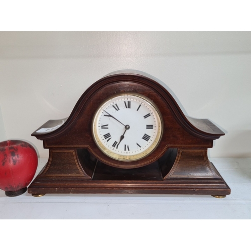 715 - An early twentieth century mahogany mantel clock with brass accents, featuring a domed top and Roman... 