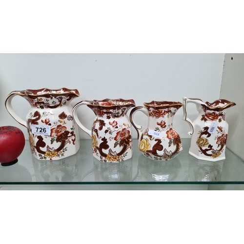 726 - A selection of four Mason's Ironstone 'Brown Velvet' pitchers, hand-painted with floral patterns, ma... 