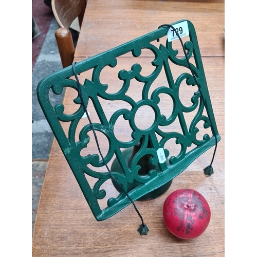 729 - A vintage green cast iron recipe book stand with decorative detailing