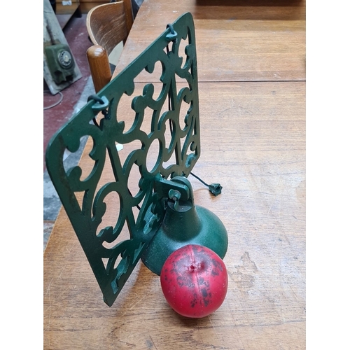 729 - A vintage green cast iron recipe book stand with decorative detailing