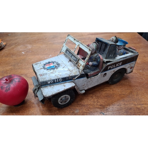 733 - A vintage DAIYA tin police jeep with figures, made in Japan. Marked 