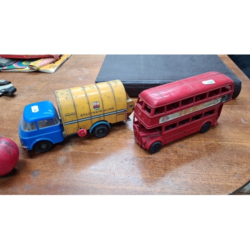 737 - A vintage die-cast toy vehicles set including a red double-decker 'Golden' bus and a blue and yellow... 