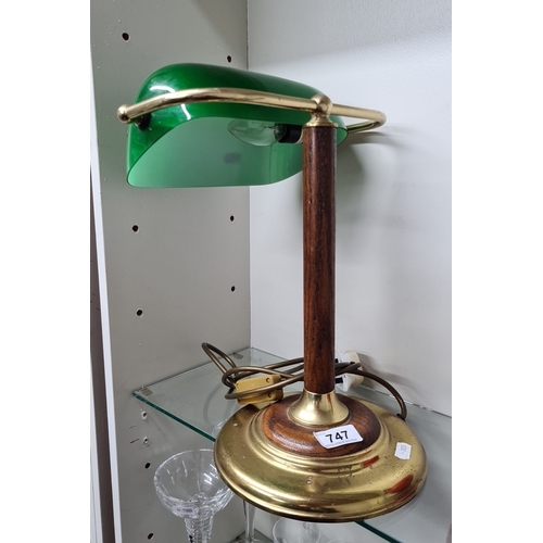 747 - A vintage brass and wood banker’s desk lamp featuring a green glass shade. Classic design with a stu... 