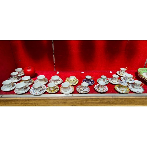 255 - Forty gorgeous pieces of delicate porcelain comprising of miniature cups and saucers all decorated i... 