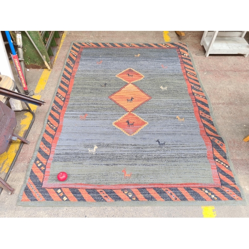 295 - A lovely large  rug featuring animal and geometric design. In tones of blue, green and orange. MM 22... 