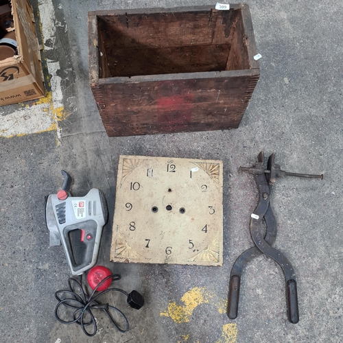 309 - A vintage hand crate containing a metal square grand father clock face and an Orbit sander and a hea... 