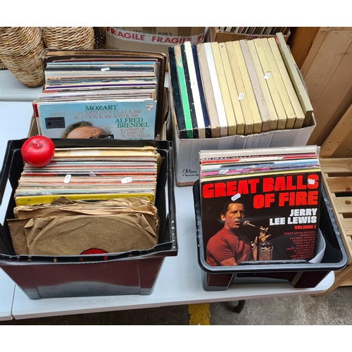 312 - Four boxes of a large collection of  vinyl records from artists such as Jerry Lee Lewis, The Drifter... 