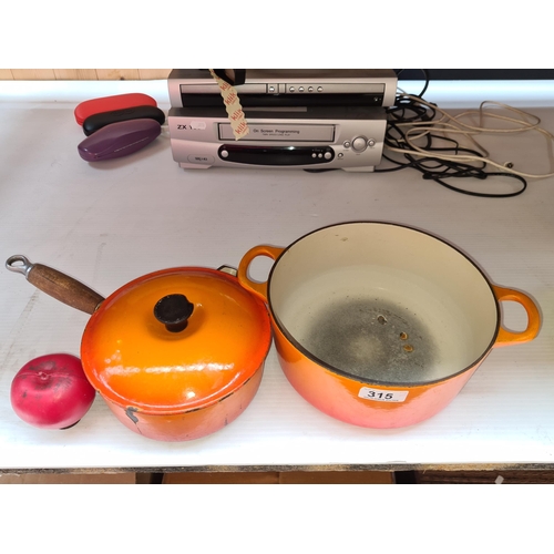 315 - Two Le Creuset dishes including one handled oven dish and one saucepan with spout and wooden handle.... 