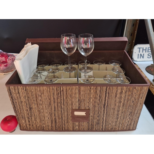 324 - A nice woven storage box comprising of 24 stemmed wine glasses.