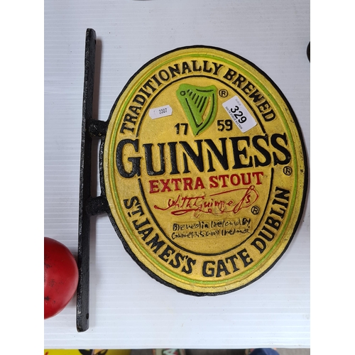 329 - A cast metal wall plaque advertising Guinness.