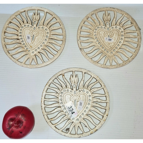 334 - Three circular heavy cast metal trivet stands.