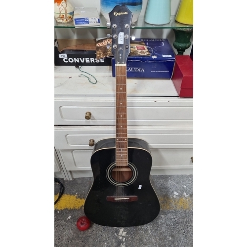 711 - An Epiphone acoustic guitar, black finish, six strings, featuring a spruce top and mahogany body. De... 