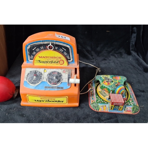 751 - Two vintage children's toys. Includes a Matchbox Superfast Superbooster and a colorful windup tin to... 