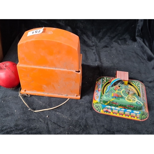 751 - Two vintage children's toys. Includes a Matchbox Superfast Superbooster and a colorful windup tin to... 