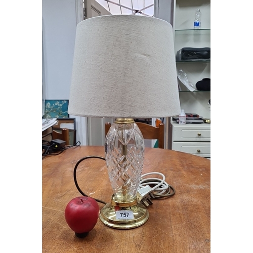 757 - A cut crystal table lamp with brass accents and cream fabric shade. Features an intricate diamond pa... 