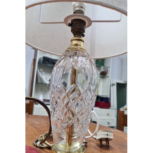 757 - A cut crystal table lamp with brass accents and cream fabric shade. Features an intricate diamond pa... 