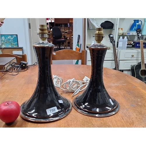 758 - A pair of vintage ceramic table lamps with broad bases, featuring a glossy dark brown glazed finish.... 