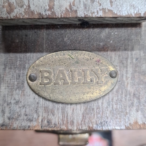 767 - A vintage Bally shoe shine kit, including wooden box, various brushes, polishes, and cloths. Branded... 