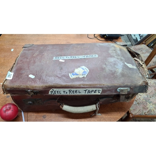 768 - A vintage leather case containing assorted reel-to-reel audio tapes, including BASF and AGFA brands.... 