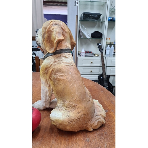 771 - A very cute St. Bernard dog figurine with rescue barrel. Approximate height: 12 inches.